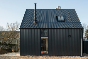 A black metal-clad building in the Cotswolds